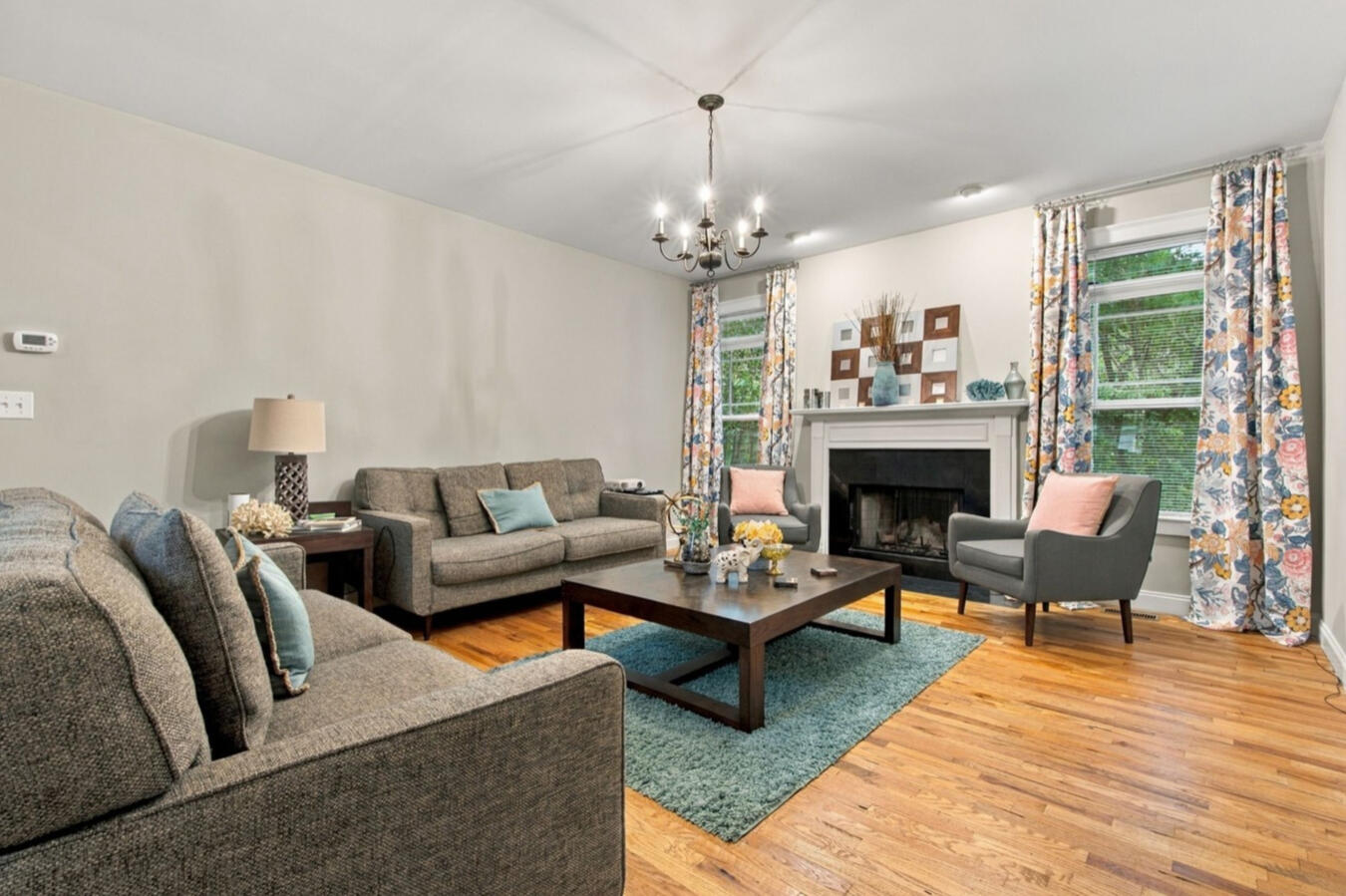 Living room with a fireplace, hardwood floors, and natural light